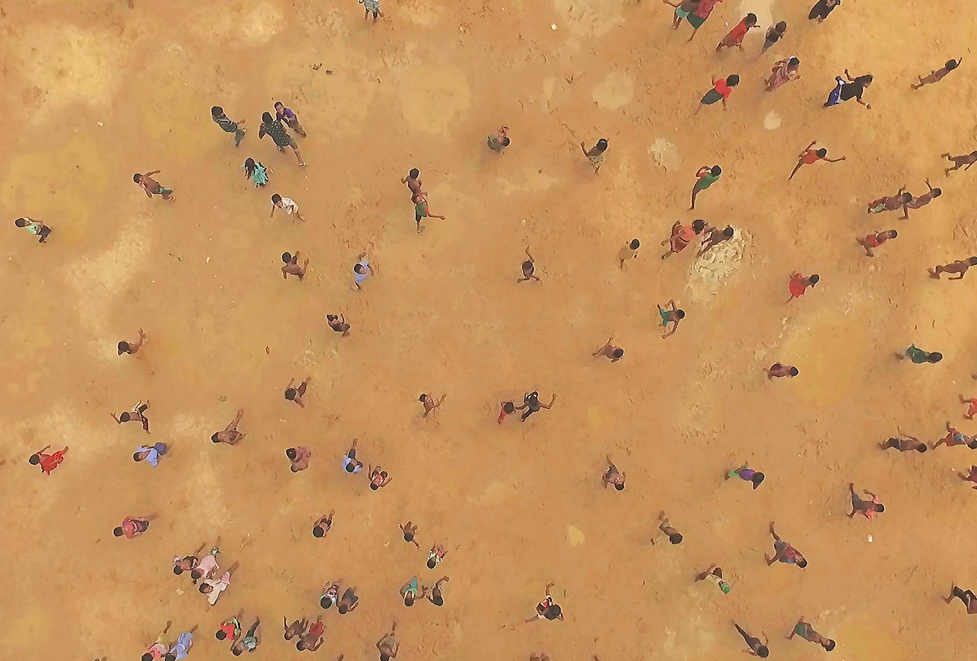 Refugees walking near Idomeni Camp, Greece in HUMAN FLOW, an Amazon Studios release. Photo courtesy of Amazon Studios.