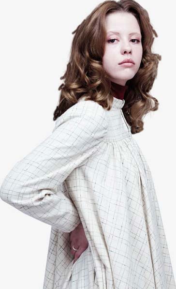 Sara stands in profile; hands on her back, and a long dress flowing over her pregnant stomach.