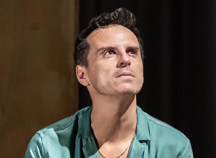 Vanya show image. Andrew Scott dressed in a green short-sleeved shirt sits on a stool.