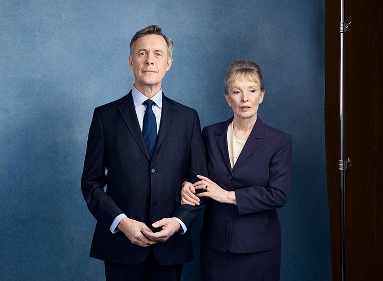 Show image of Lindsay Duncan and Alex Jennings as Diana and Robin Hesketh standing together with arms linked posing for a photograph.