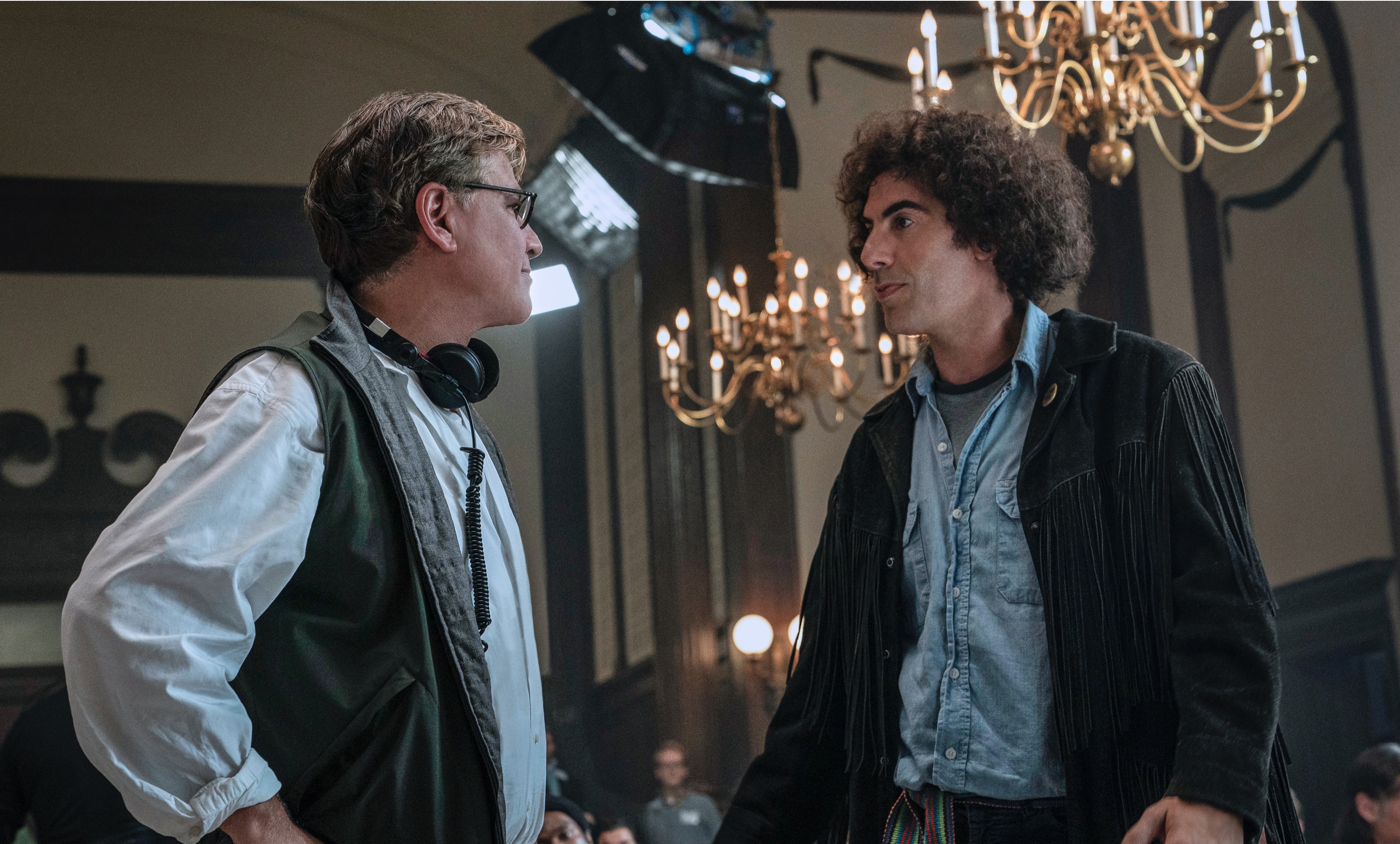Aaron Sorkin directs Sacha Baron Cohen between takes for The Trial of the Chicago 7.
